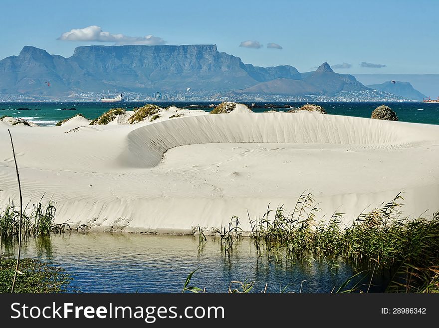 Landscape with white sand dune and Table mountain in the background