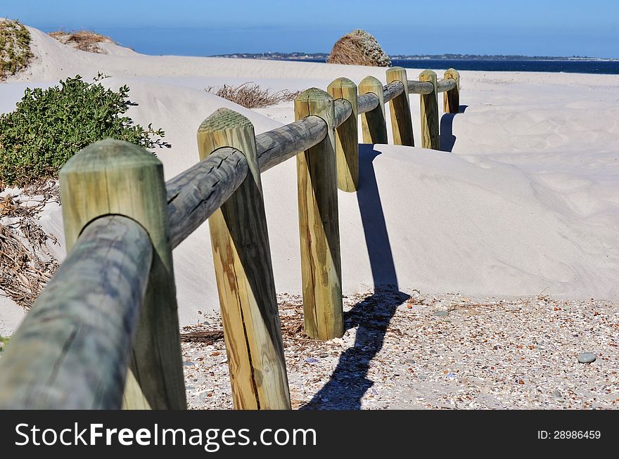 Landscape with wooden poles in white beach sand. Landscape with wooden poles in white beach sand