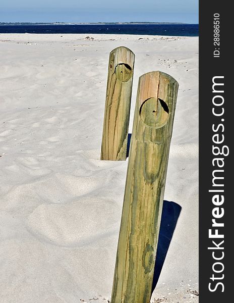 Landscape with wooden poles in white beach sand. Landscape with wooden poles in white beach sand