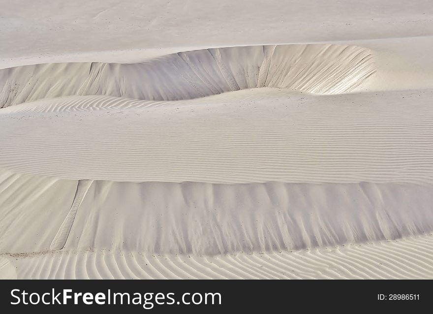 Landscape with migrating white sand dune on the coast