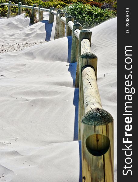 Landscape with wooden poles in white beach sand. Landscape with wooden poles in white beach sand