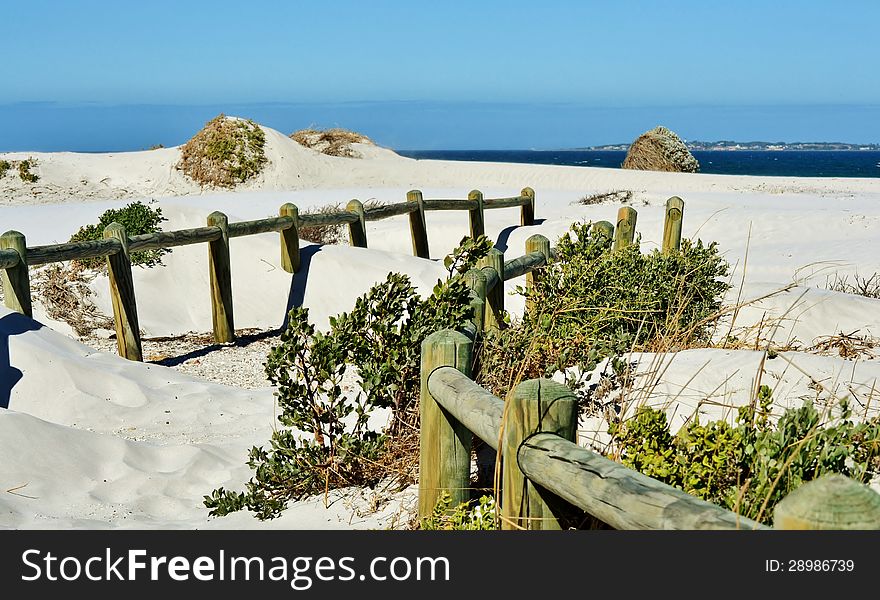 Landscape with wooden poles in white beach sand. Landscape with wooden poles in white beach sand