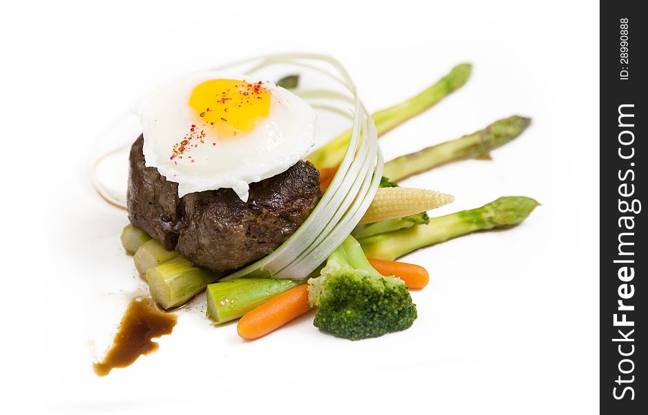 Meat steak fried egg top, variety garnish vegetables. Meat steak fried egg top, variety garnish vegetables