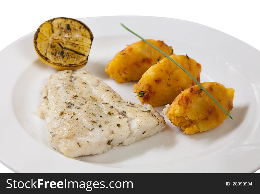 Fish fillet with potato cutlets on a white plate. Fish fillet with potato cutlets on a white plate