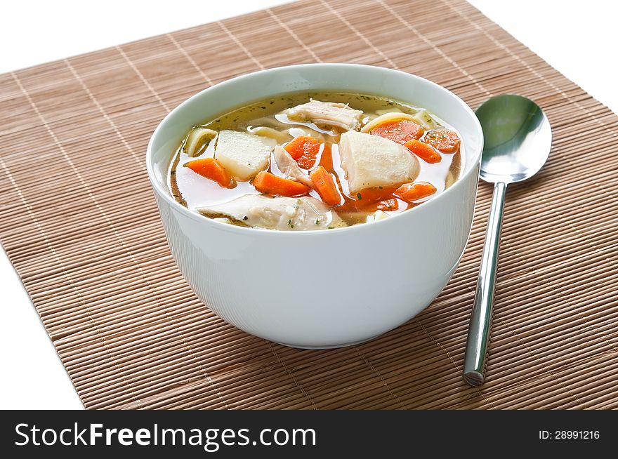 Bowl of chicken soup with vegetables and noodles