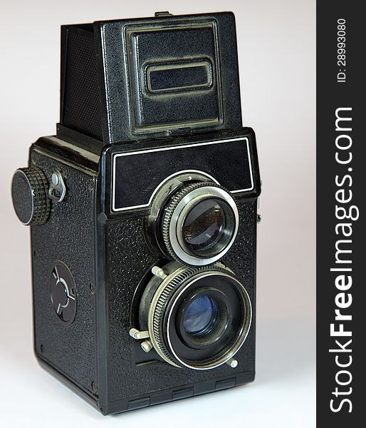 Old vitage camera with two lenses on light background