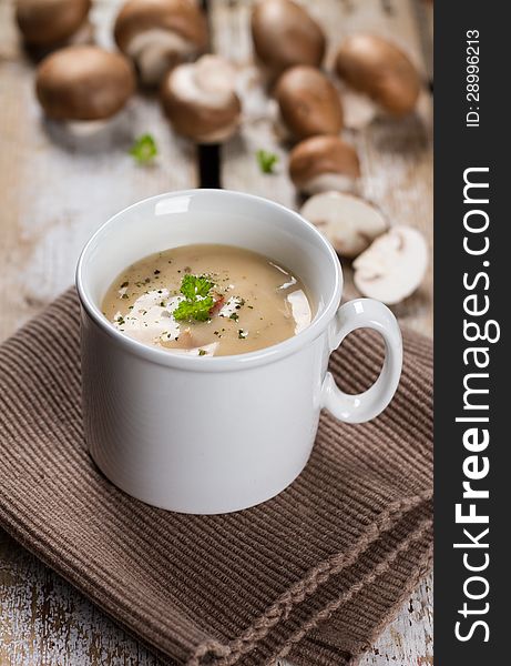 A cup or mug of creamy mushroom soup.