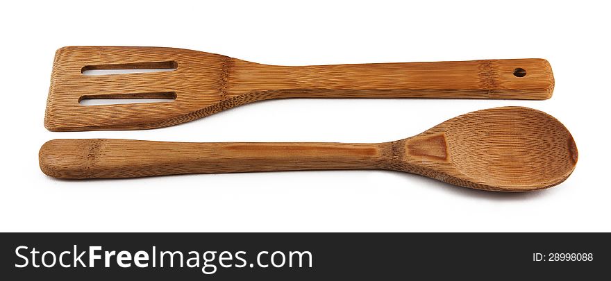 Almonds and wooden spoon on white background