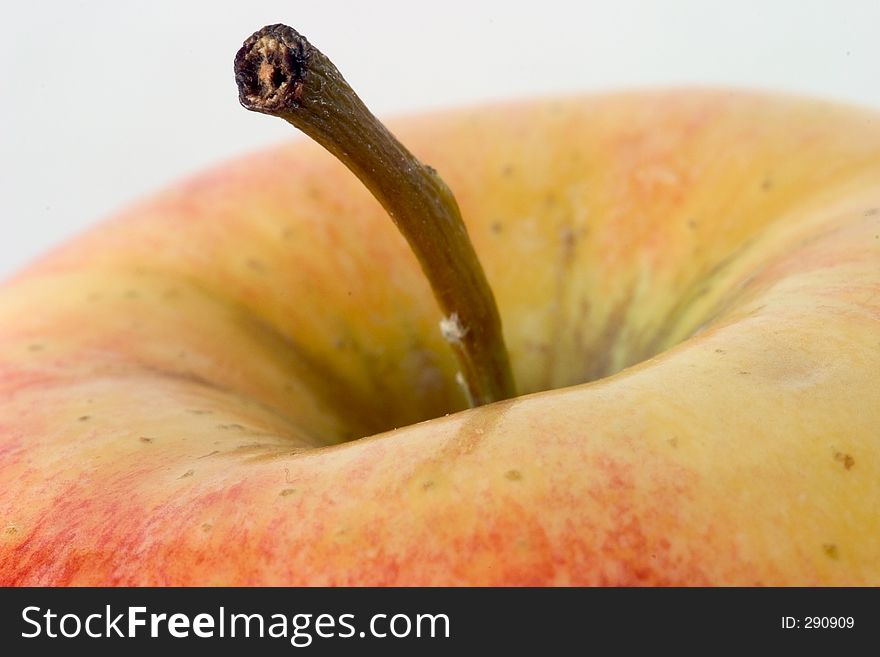 Close-up of the top of an apple, with the main focus on the stem. Close-up of the top of an apple, with the main focus on the stem.