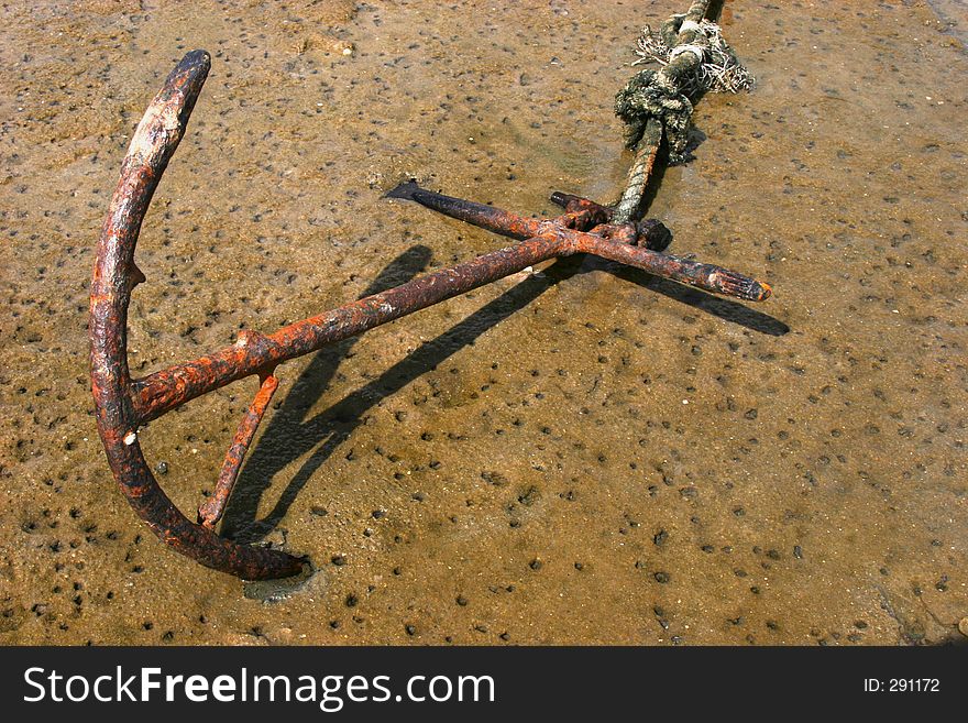 Rusted Anchor in shallow sea water