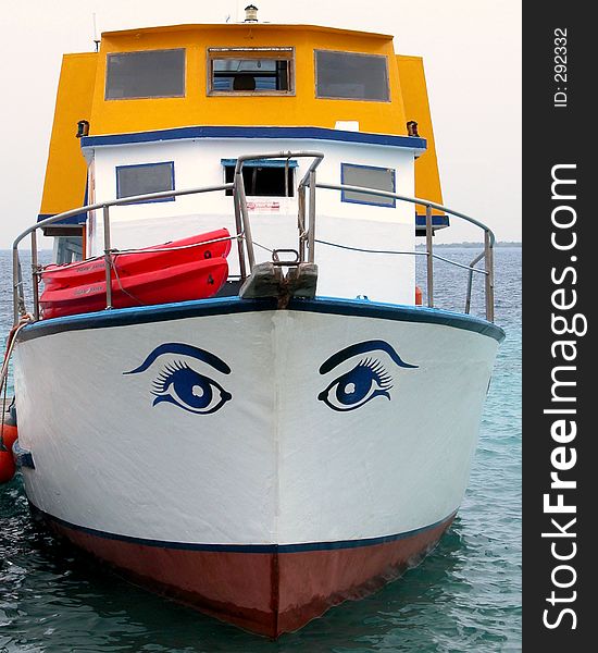 Head on view of an old boat with eyes painted on it. Head on view of an old boat with eyes painted on it