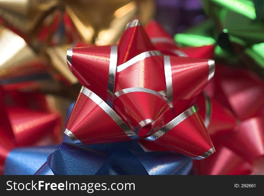 Red and Silver Christmas Bow laying on a variety of other bows