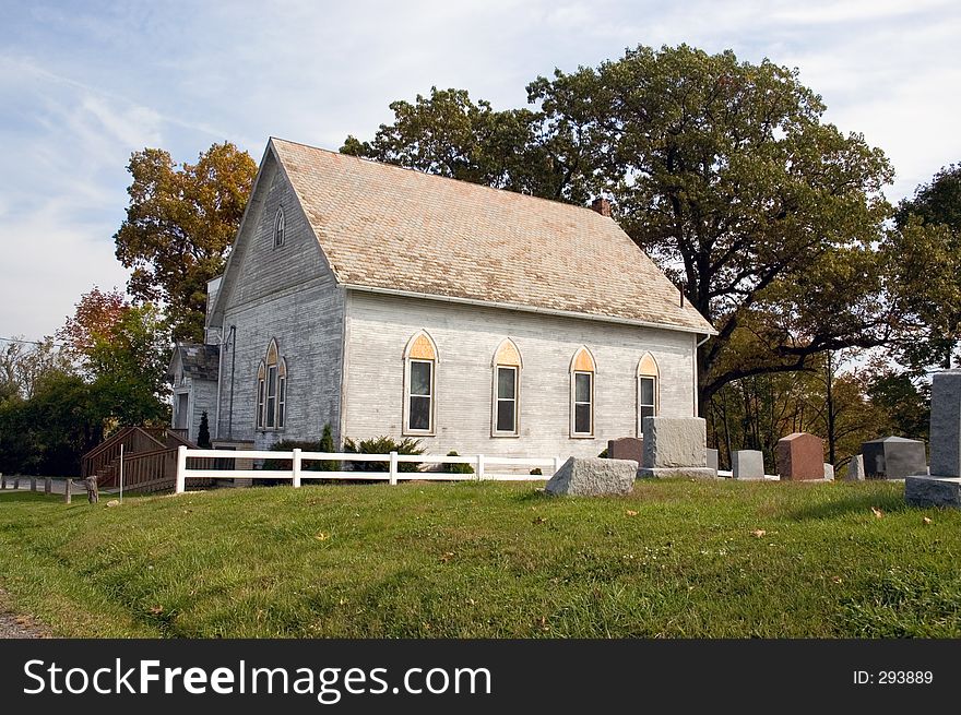 A small country church with a graveyard. A small country church with a graveyard.