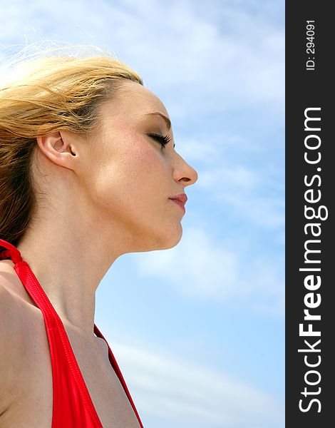 Photo of a model feeling the breeze in her hair. Photo of a model feeling the breeze in her hair.