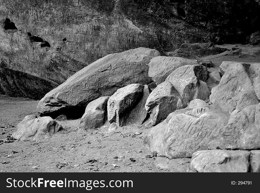 Black and white image of names carved into rocks. Black and white image of names carved into rocks.