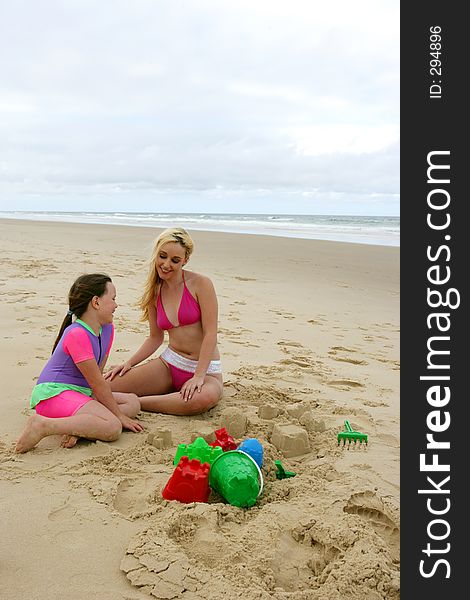 Teen and child having fun on the beach. Teen and child having fun on the beach.