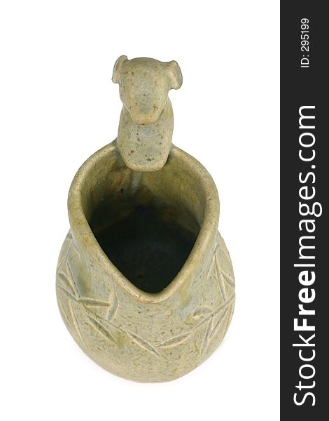 A unique clay sculpted creamer or jug with a dog design as the handle and tradisional bamboo carvings on side. A unique clay sculpted creamer or jug with a dog design as the handle and tradisional bamboo carvings on side.