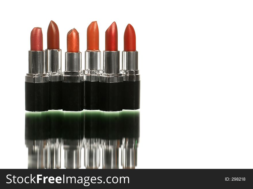 Bunch of lipsticks on white with reflection shot horizontal