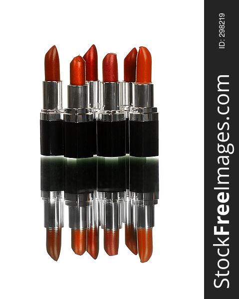 Bunch of lipsticks on white with reflection shot vertical