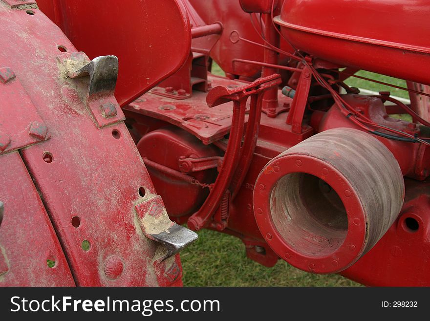 The workings of a red farm tractor. The workings of a red farm tractor