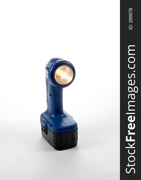 A battery operated flashlight with light on. A battery operated flashlight with light on