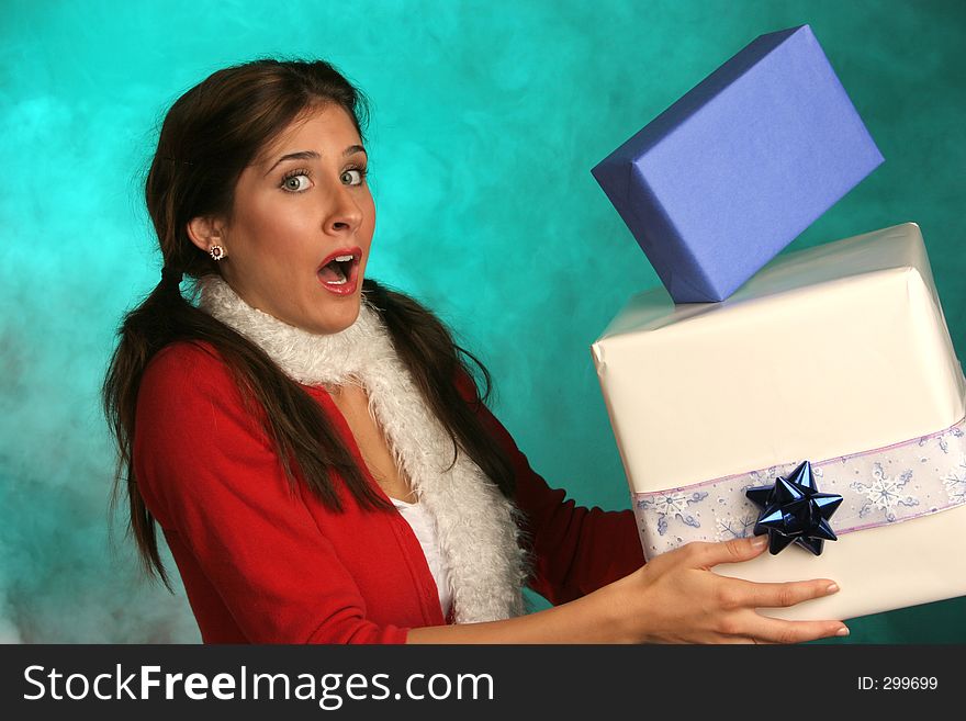 Girl with expressive face holding blue and white chanukkah boxes