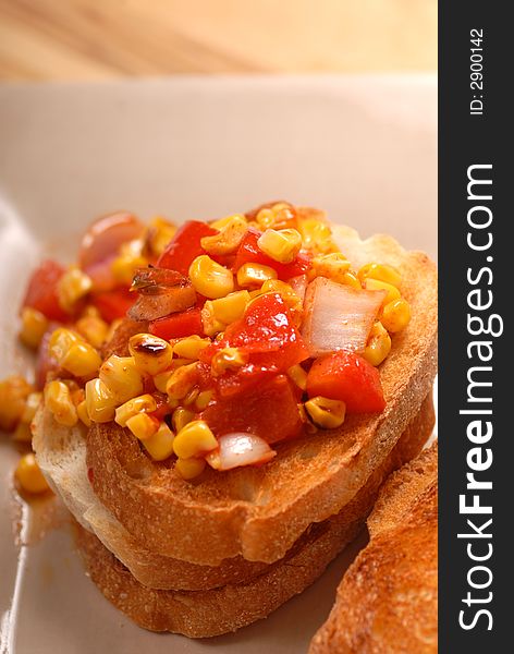 Overhead view of roasted corn, tomato and onion bruschetta. Overhead view of roasted corn, tomato and onion bruschetta