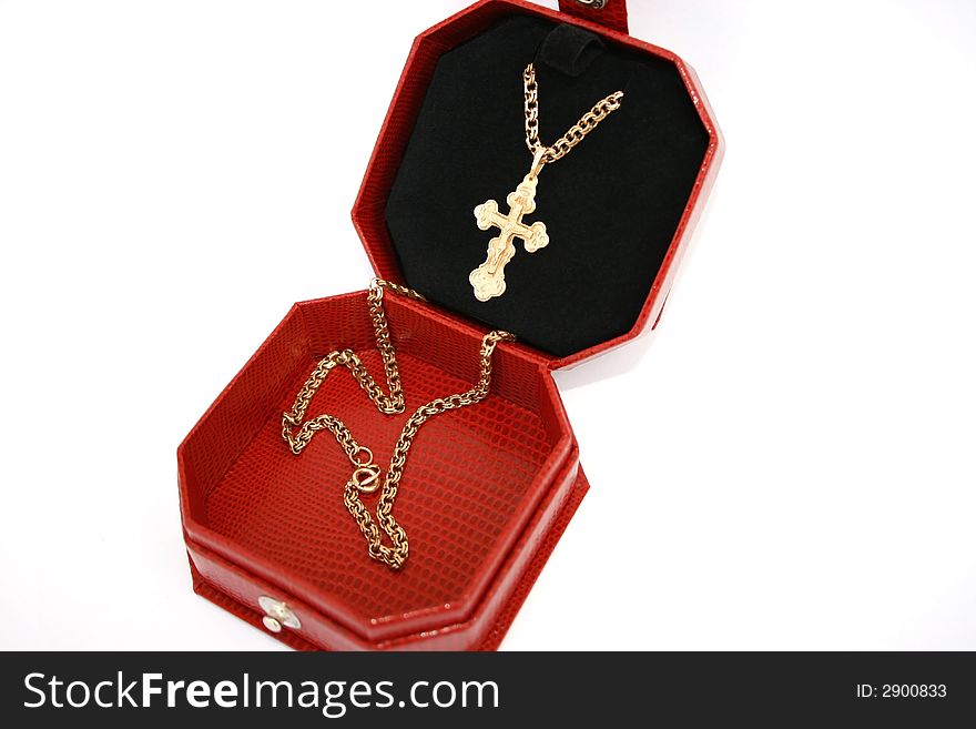 Golden cross and chain in the jewelery box.