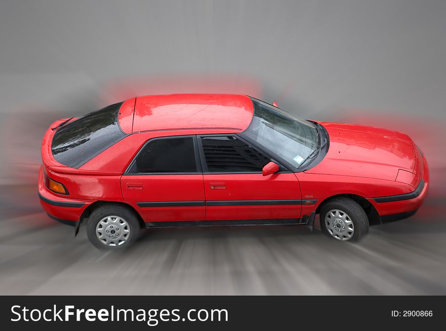 The image of the red car in movement. The image of the red car in movement