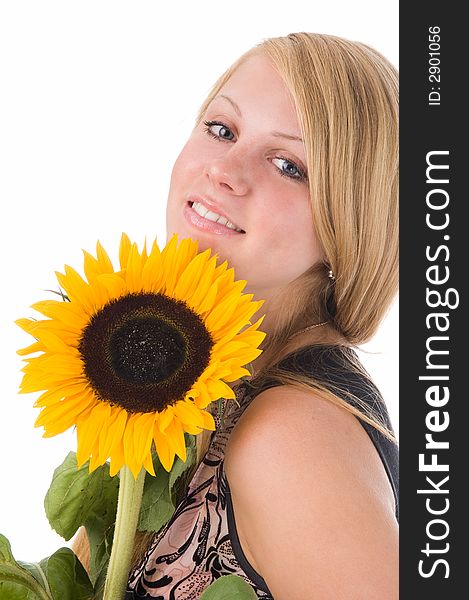 The attractive blonde in studio holds a sunflower in hands. The attractive blonde in studio holds a sunflower in hands