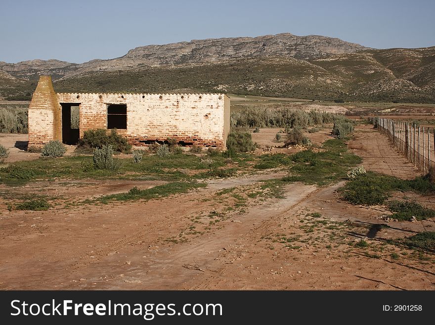 Evacuated old farmhouse near a mountain