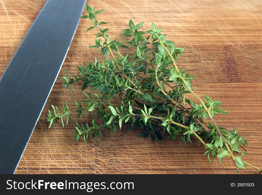 Thyme on a chopping board with knife. Thyme on a chopping board with knife