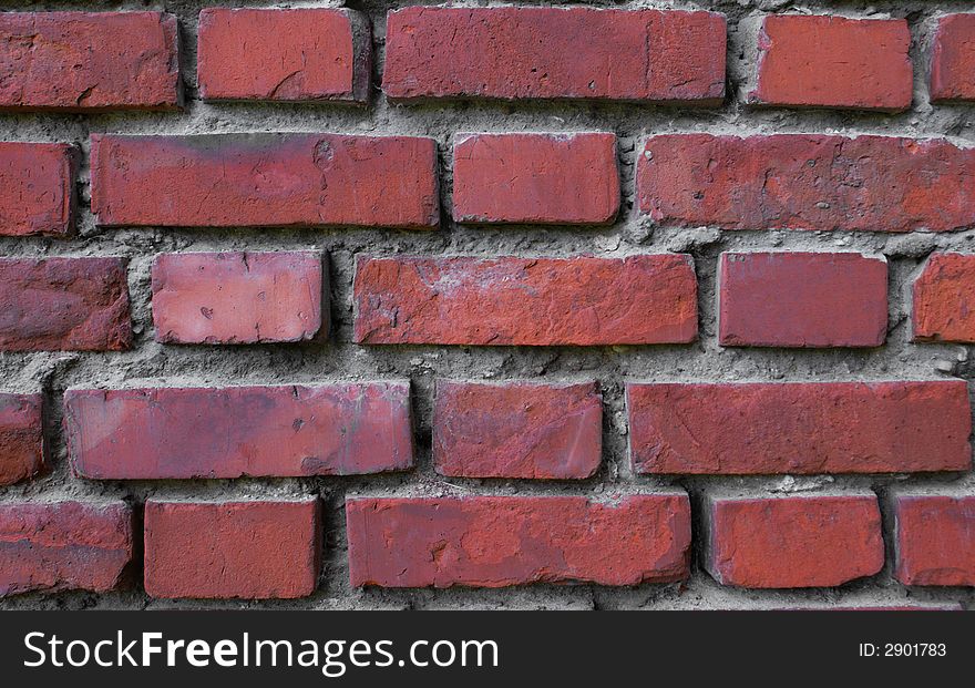 A decorative background; a wall from a red brick; a strong traditional building material. A decorative background; a wall from a red brick; a strong traditional building material.