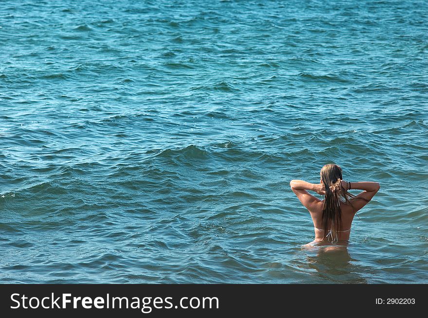 Female torso on sea backgroung