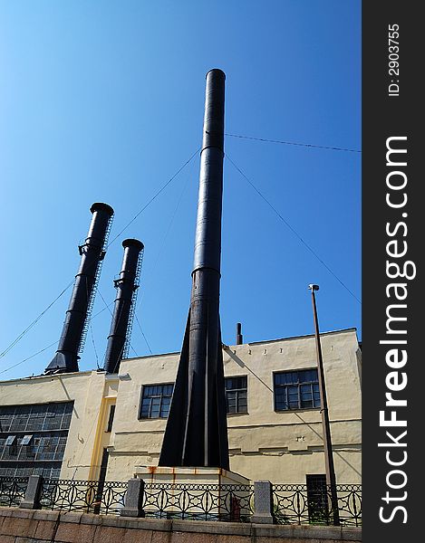 The old factory with a few big pipes.