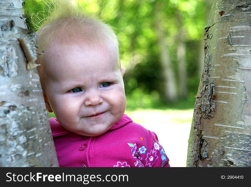 Little Baby Girl getting photo taken by tree. Little Baby Girl getting photo taken by tree