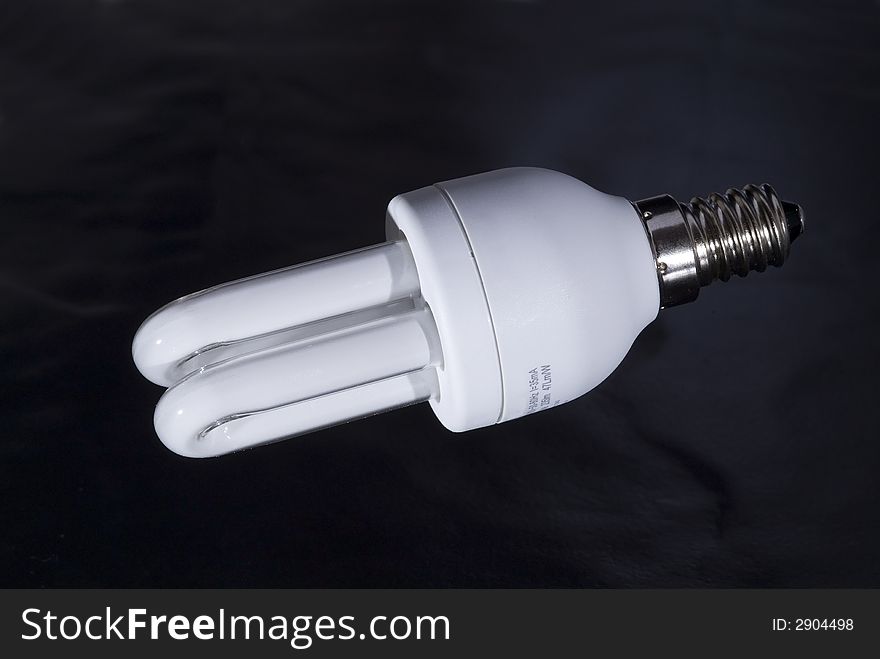 Energy saving light bulb, on a black background