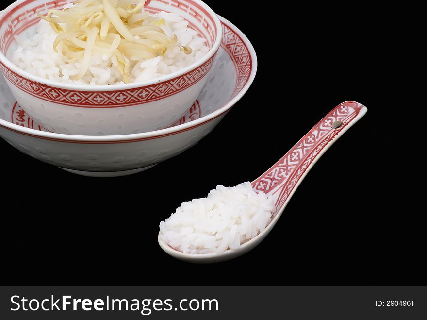 Chinese bowl with rice against black background. Chinese bowl with rice against black background.