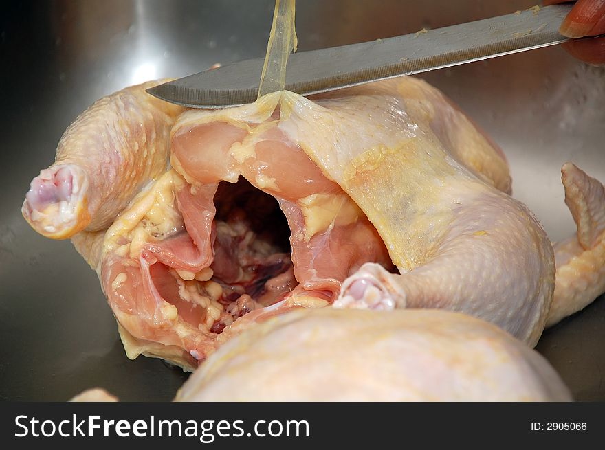 Removing fat from whole raw chicken. Removing fat from whole raw chicken