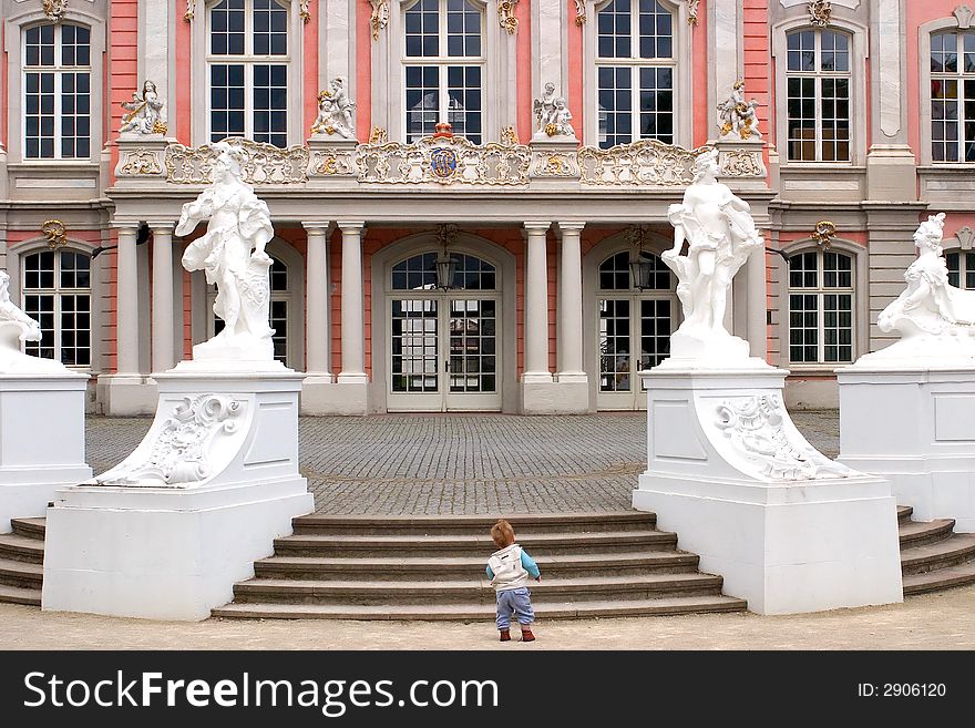 Little boy in front of a fancy manor. Little boy in front of a fancy manor