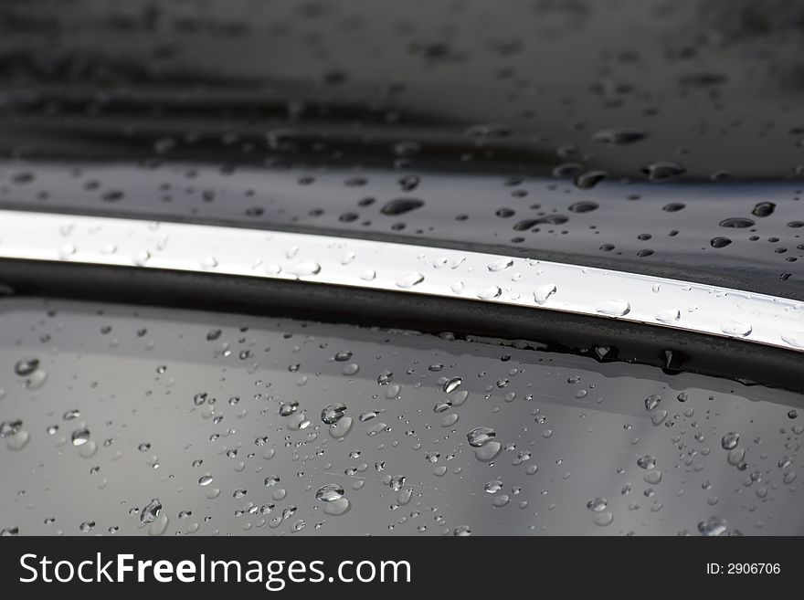 Water drops on black car surface. Water drops on black car surface.