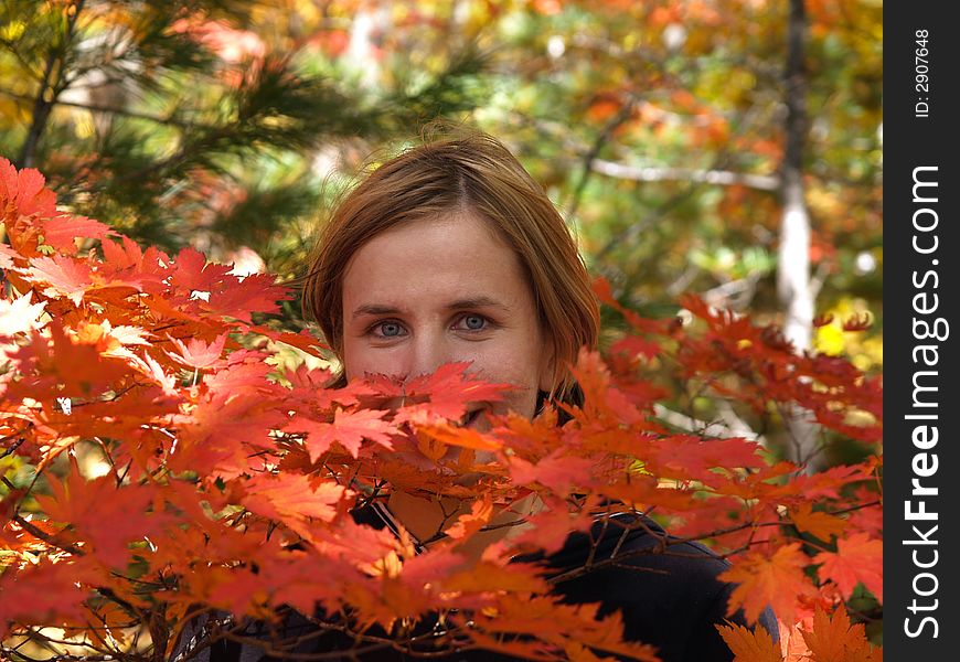 Happy girl in maple forest