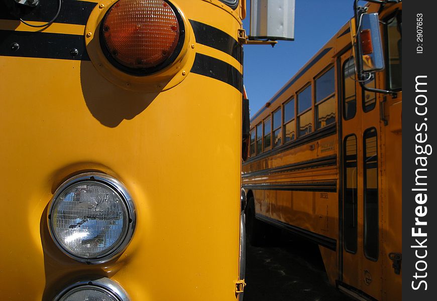 Details of school bus with headlight and orange turn signal. Details of school bus with headlight and orange turn signal