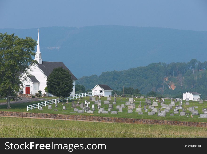 A Mountain countryside with a cemetery and church