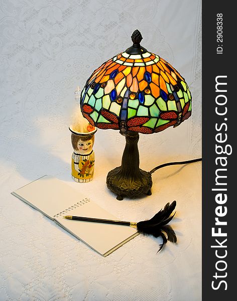 Lit lamp with notepad and pen