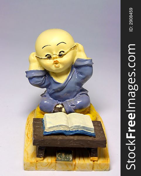 Sculpture of little monk reading book. Sculpture of little monk reading book.