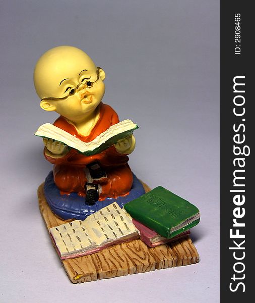 Sculpture of little monk reading book. Sculpture of little monk reading book.