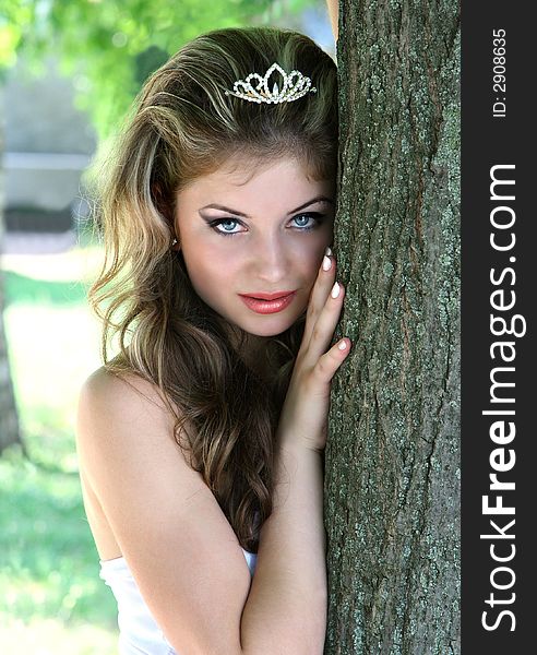 Beauty Girl in white dress near tree