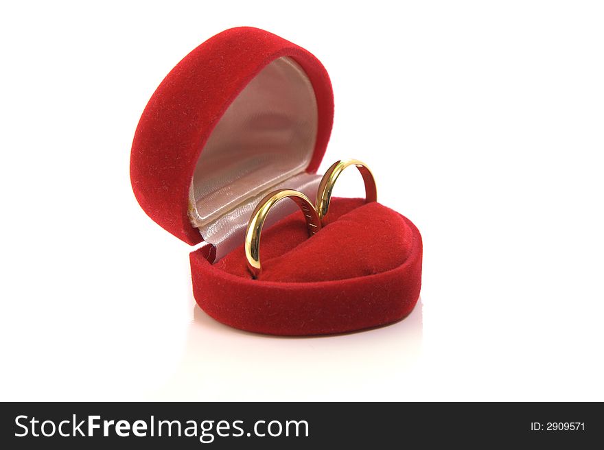 Gold wedding rings in red box isolated on white