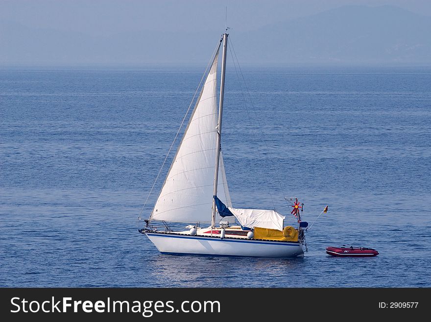 Empty small yacht sailing on blue sea waters. Empty small yacht sailing on blue sea waters